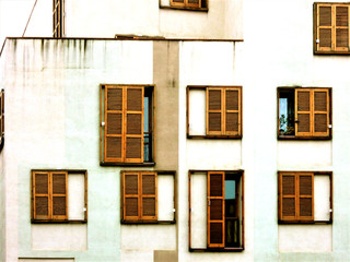 Barcelona. Wooden oak shutters. Europe's city. Windows on the white modern facade.