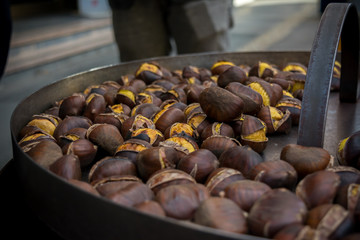 Selling of Chestnuts in an Italian Street called Caldarroste in Autumn on bLur Background.