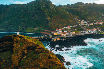 Aerial Madeira island view with Atlantic ocean, white waves, cliffs and green nature
