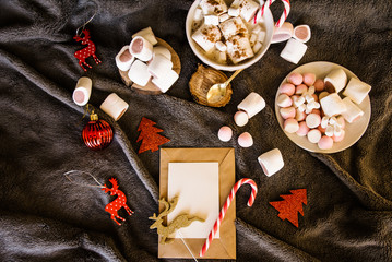 Obraz na płótnie Canvas Good New Year spirit. Coffee with marshmallows and cinnamon. Pink mug. Cooking yourself.Home comfort. New Year. Christmas time. Winter mood.Letter to Santa Claus. To Do list.New Year resolution