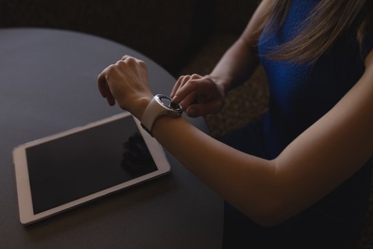 Female executive using smartwatch in office