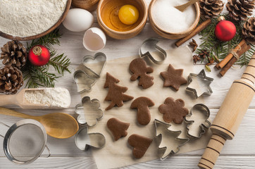 Decorative New Year bakery with molds and ingredients on a wooden white background. Top view.