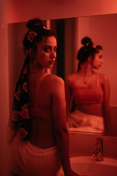 Charming young lady in mirror in redness