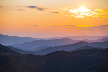 mountain valley in a mist at the sunset