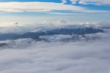 winter mountain ridge in a dense clouds