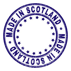 MADE IN SCOTLAND stamp seal imprint with grunge texture. Designed with circles and stars. Blue vector rubber print of MADE IN SCOTLAND text with grunge texture.