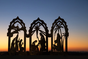Silhouette photograph of a Christmas nativity scene against the sunset