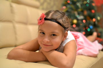 Obraz na płótnie Canvas Happy teen girl near decorated Christmas tree waiting for a miracle.
