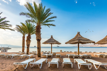 Relaxing  atmosphere on central public beach of Eilat - famous tourist resort  and recreational city in Israel. Concept of healthy vacation