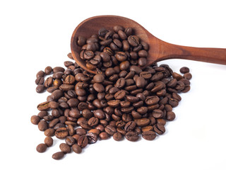 Roasted coffee beans on a wooden spoon on a white background