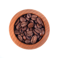 Roasted coffee beans in wooden cup on a white background