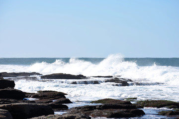 Fototapeta na wymiar Waves Crashing Into Rock Pools As The Tide Comes In, Uvongo, South Africa