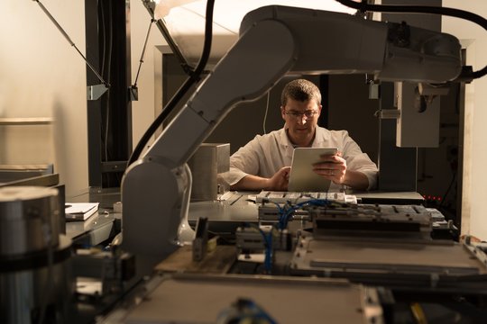 Robotic engineer using digital tablet