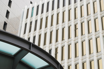 Abstract urban background featuring detail of modern tall office buildings in downtown Tokyo, Japan, with windows textures. 