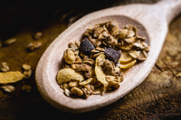 wooden spoon with oats, cereal and seeds.