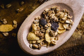 wooden spoon with oats, cereal and seeds.