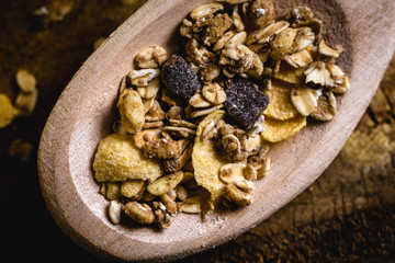 wooden spoon with oats, cereal and seeds.