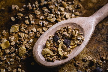 wooden spoon with oats, cereal and seeds.
