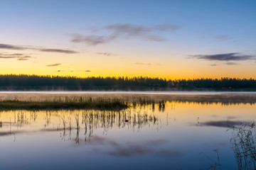 Fototapeta na wymiar Early morning on the lake in the Leningrad region.