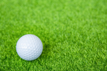 Golf ball on green grass ready to play at golf course. with copy space