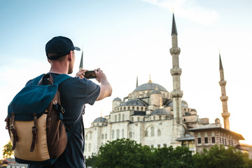 Tourist photographs the Blue Mosque in Istanbul in Turkey for memory.