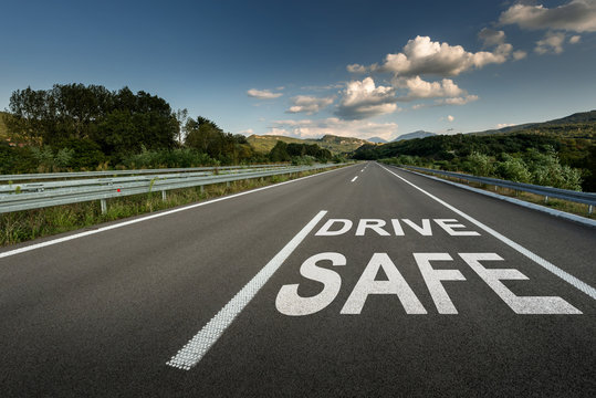 Drive safe message on Asphalt highway road through the countryside to the mountains
