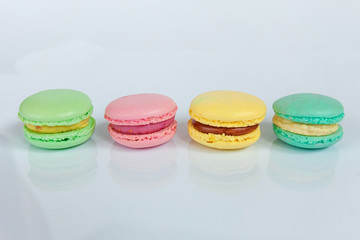 Sweet almond colorful pink, blue, yellow, green macaron or macaroon dessert cake isolated on white background. French sweet cookie. Minimal food bakery concept. Flat lay, top view, copy space