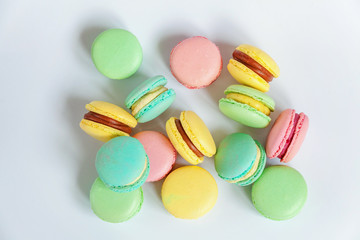 Sweet almond colorful pink, blue, yellow, green macaron or macaroon dessert cake isolated on white background. French sweet cookie. Minimal food bakery concept. Flat lay, top view, copy space