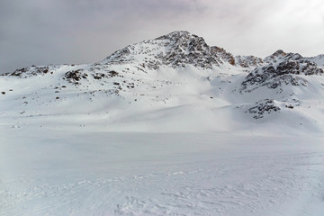 Fototapeta na wymiar Panoramic view of the snow-covered Alps in winter, in the canton of Graubünden in Switzerland.