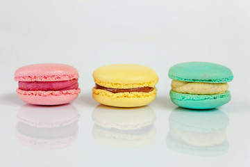 Sweet almond colorful pink, blue, yellow macaron or macaroon dessert cake isolated on white background. French sweet cookie. Minimal food bakery concept. Copy space