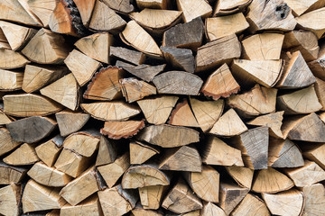 Dry chopped firewood logs ready for winter, Firewood wall background texture