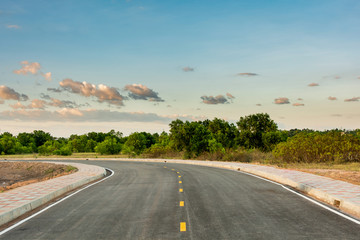 Fototapeta na wymiar Empty asphalt road curve and clean blue sky in summer day background with copy space