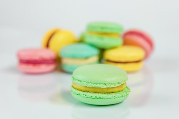 Sweet almond colorful pink, blue, yellow, green macaron or macaroon dessert cake isolated on white background. French sweet cookie. Minimal food bakery concept. Flat lay, top view, copy space