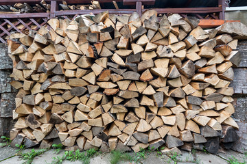 Dry chopped firewood logs ready for winter, Firewood wall background texture