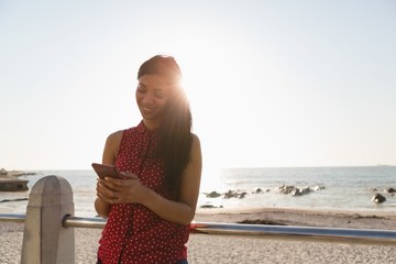 Woman using mobile phone at promenade