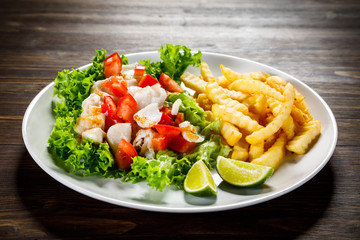 Fried cod and vegetables with french fries