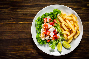 Fried cod and vegetables with french fries