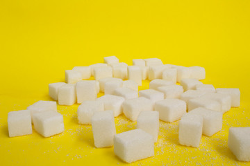 Sugar cubes isolated on yellow background