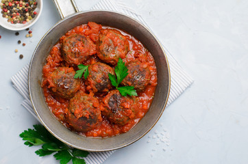 Meatballs in Tomato Sauce in a Frying Pan on Bright Backround