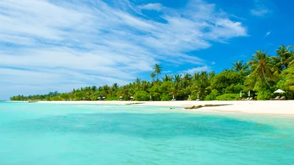 Foto op Canvas Beautiful sandy beach with sunbeds and umbrellas in Indian ocean, Maldives island © Myroslava