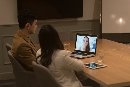 Business executives doing a video conference on laptop