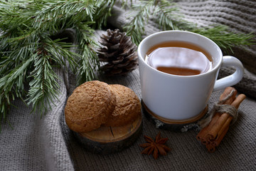 Cup of lemon tea cookies cinnamon spruce branch Winter holidays concept Cozy home