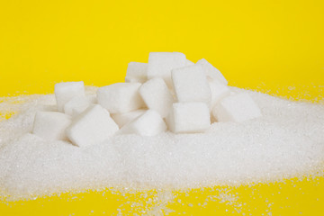 granulated and sugar cubes isolated on yellow background