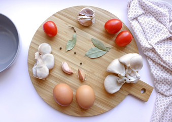kitchen board with eggs, mushrooms and spices