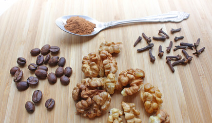 walnuts, coffee beans, clove seasoning, and a spoon of ground cinnamon