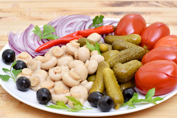 Pickles in assortment on a plate. Restaurant dish.