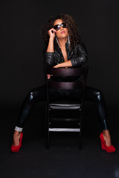 Young African American Woman In Leather Pants And Red Heels