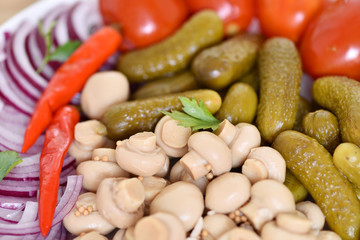 Pickles in assortment on a plate. Restaurant dish.