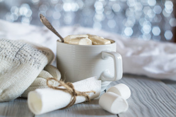 Obraz na płótnie Canvas A cup of cocoa and marshmallow in the New Year's Christmas table