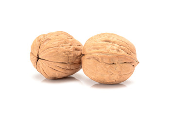 Two whole walnuts, close up macro, isolated on a white background.